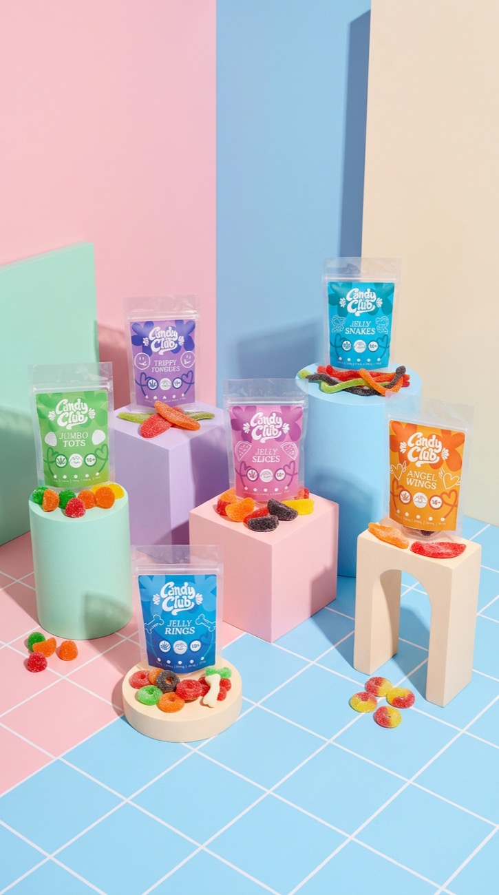 Candy Club pouches in a blue-tiled studio scene